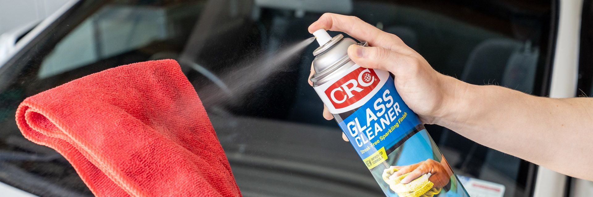 CRC Glass Cleaner being sprayed onto a microfibre cloth
